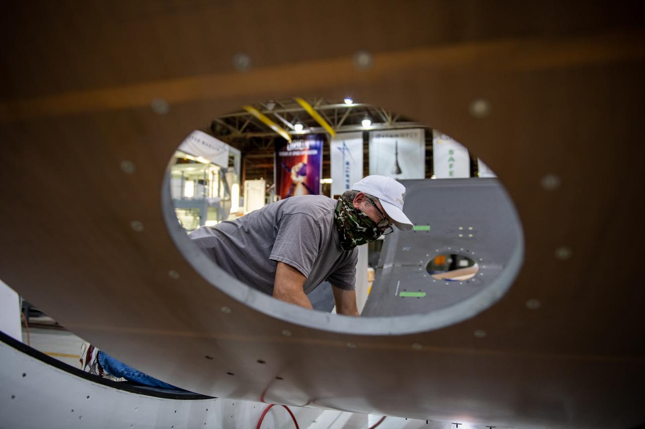 Employees wear personal protective gear at  Michoud Assembly Facility as the facility transitioned to Stage 3 of NASA’s Framework for Return To On-Site Work. Employees wear the appropriate personal protective equipment (PPE) and/or cloth face coverings as required for assigned tasks. Access to the facility is limited to authorized personnel working on mission-critical tasks that must be conducted onsite. Mission-critical tasks include slowly and methodically resuming Space Launch System (SLS) Core Stage and Orion production activities, particularly critical path deliverables to support the Artemis Program, at a pace that limits personnel and follows federal guidelines for social distancing and use of personal protective equipment such as face masks. For more information about SLS, visit nasa.gov/sls.